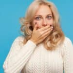 Woman shocked closing mouth (1)