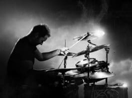 Drummer Playing The Drums With Smoke And Powder In The