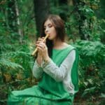 Woman in forest with flute