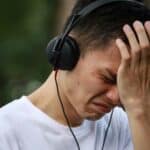 Man crying while listening to music